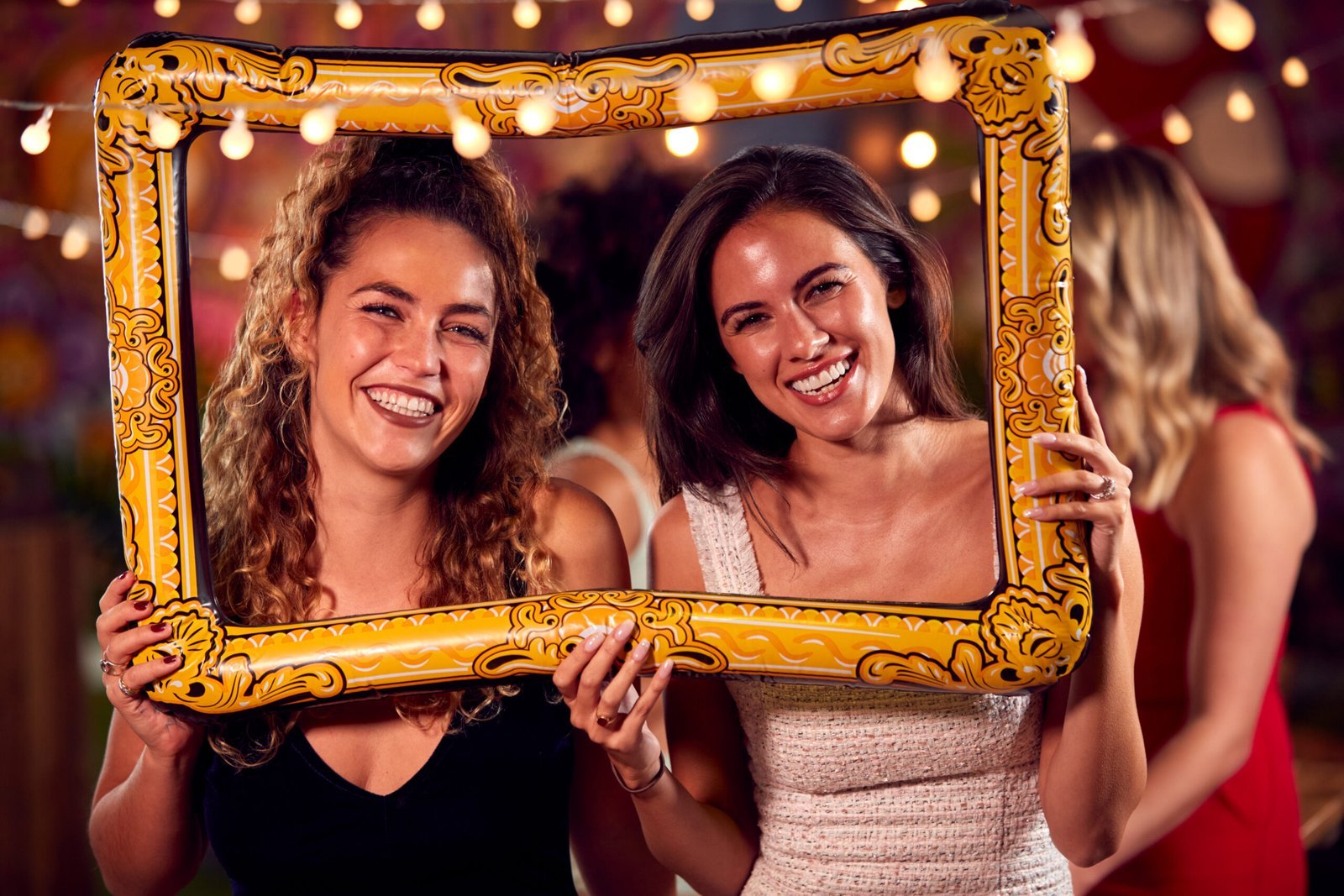 female-friends-having-fun-posing-with-photo-booth-2024-10-19-10-47-34-utc-scaled.jpg